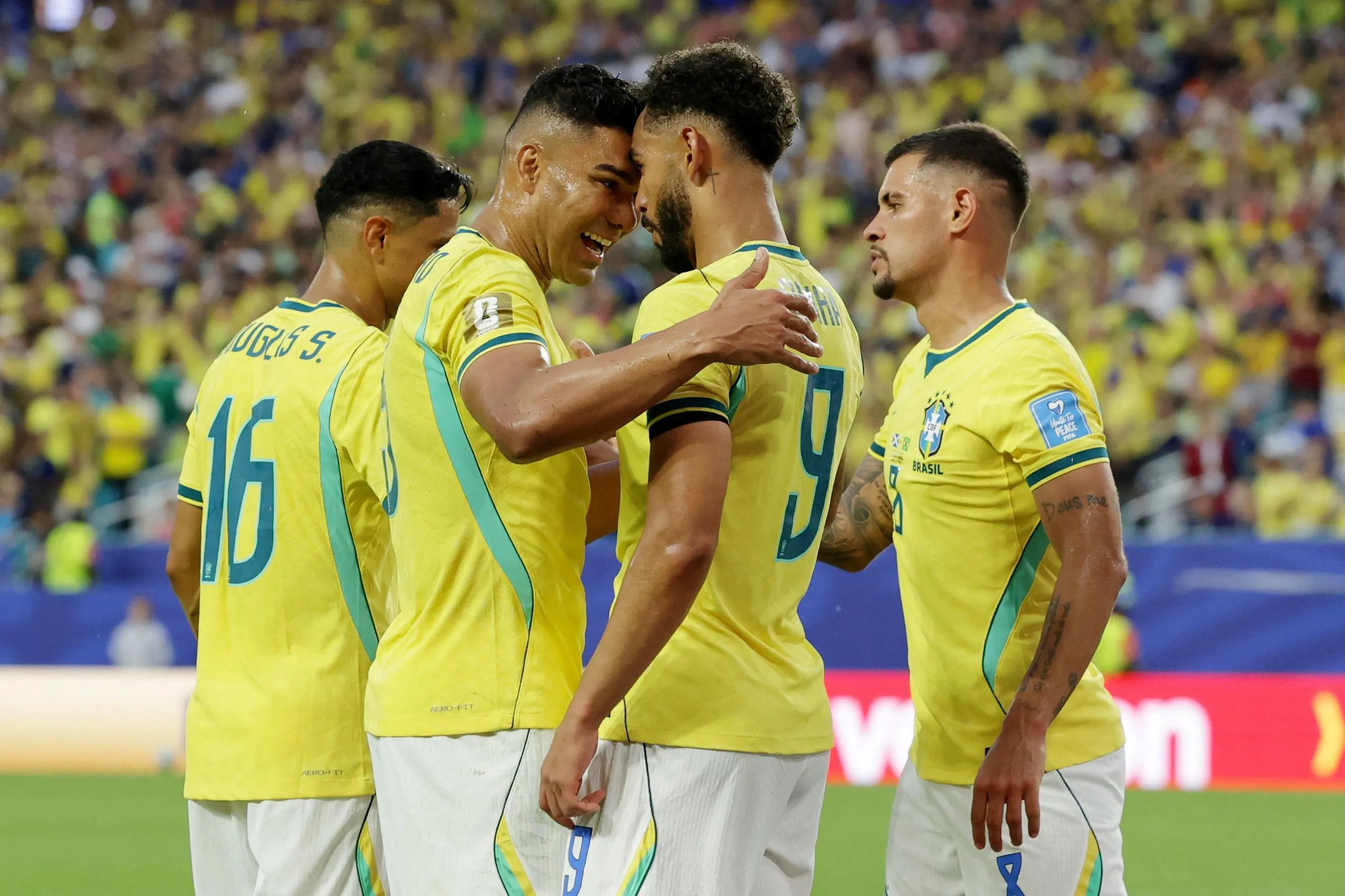 Matheus Cunha celebrates scoring their third goal with Casemiro and Bruno Guimaraes