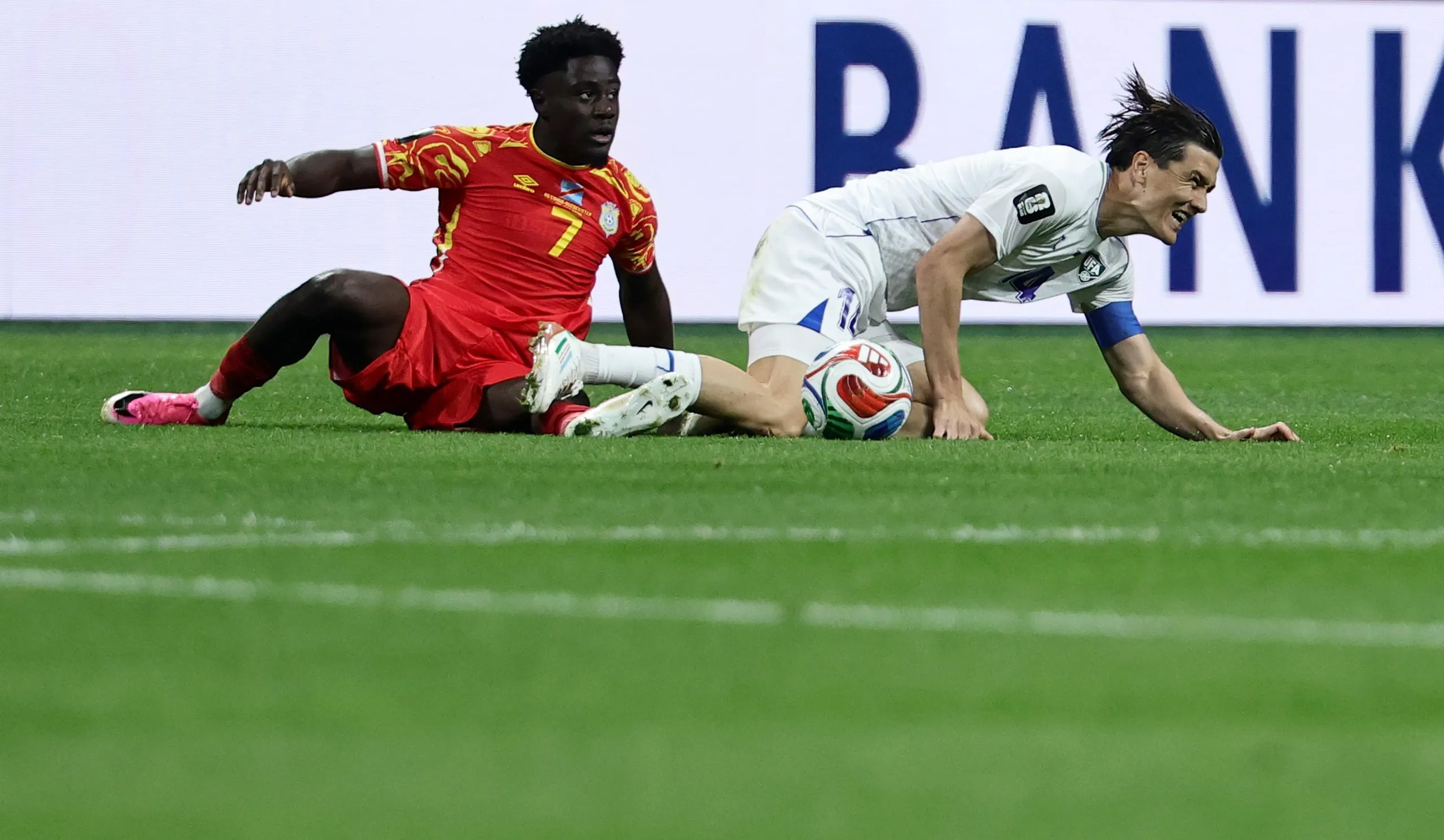 Nathanael Mbuku and Eldor Shomurodov tangle, resulting in a free-fick for DR Congo.