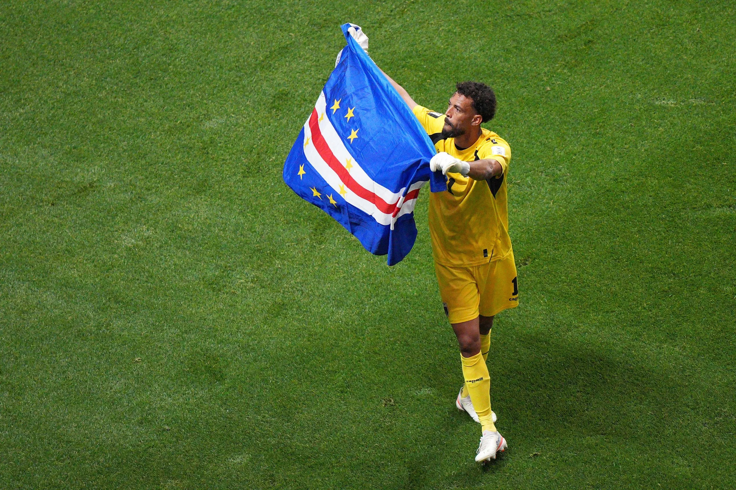 Vozinha waves a Cape Verde flag.