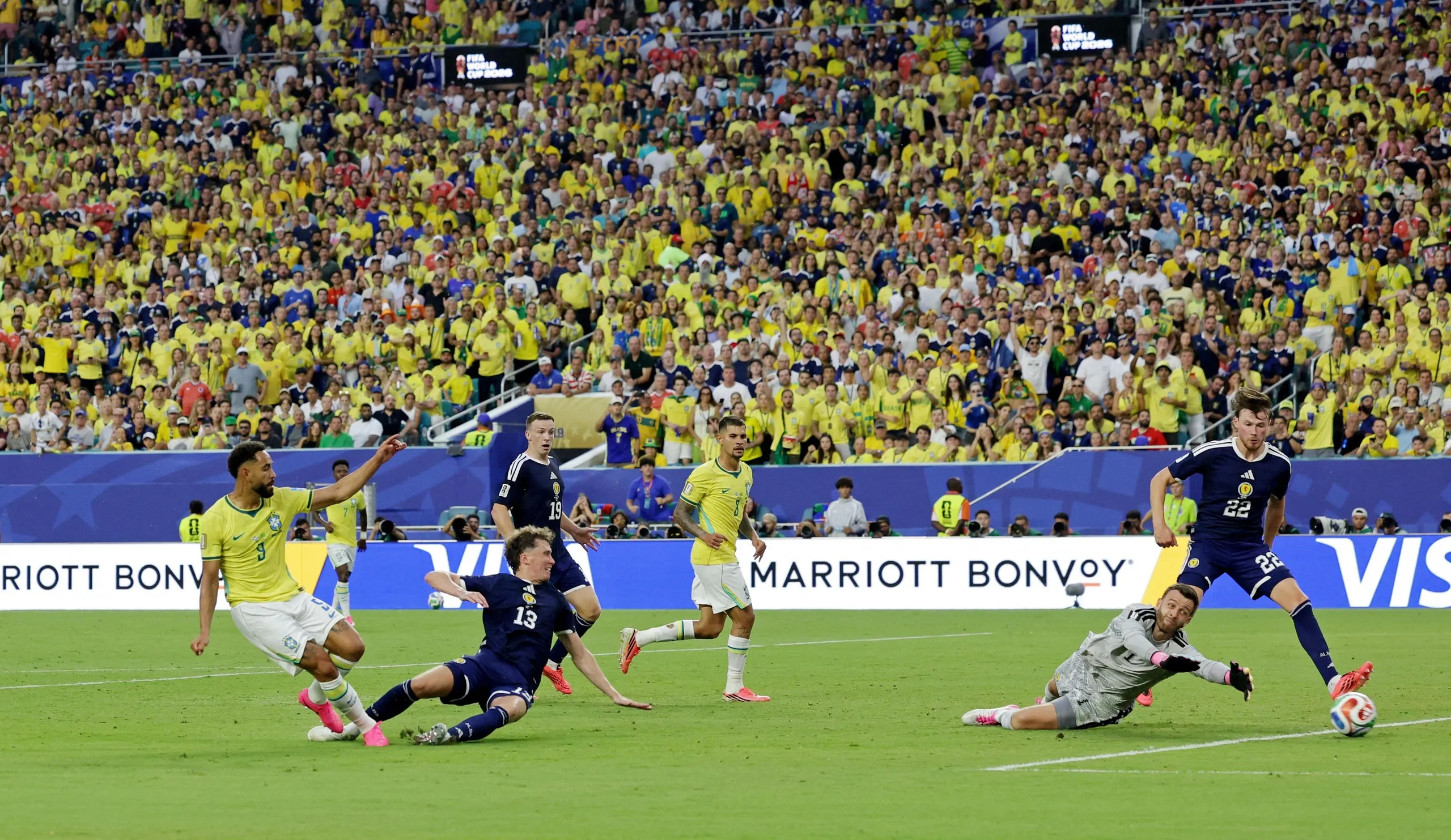 Matheus Cunha scores their third for Brazil past Angus Gunn.
