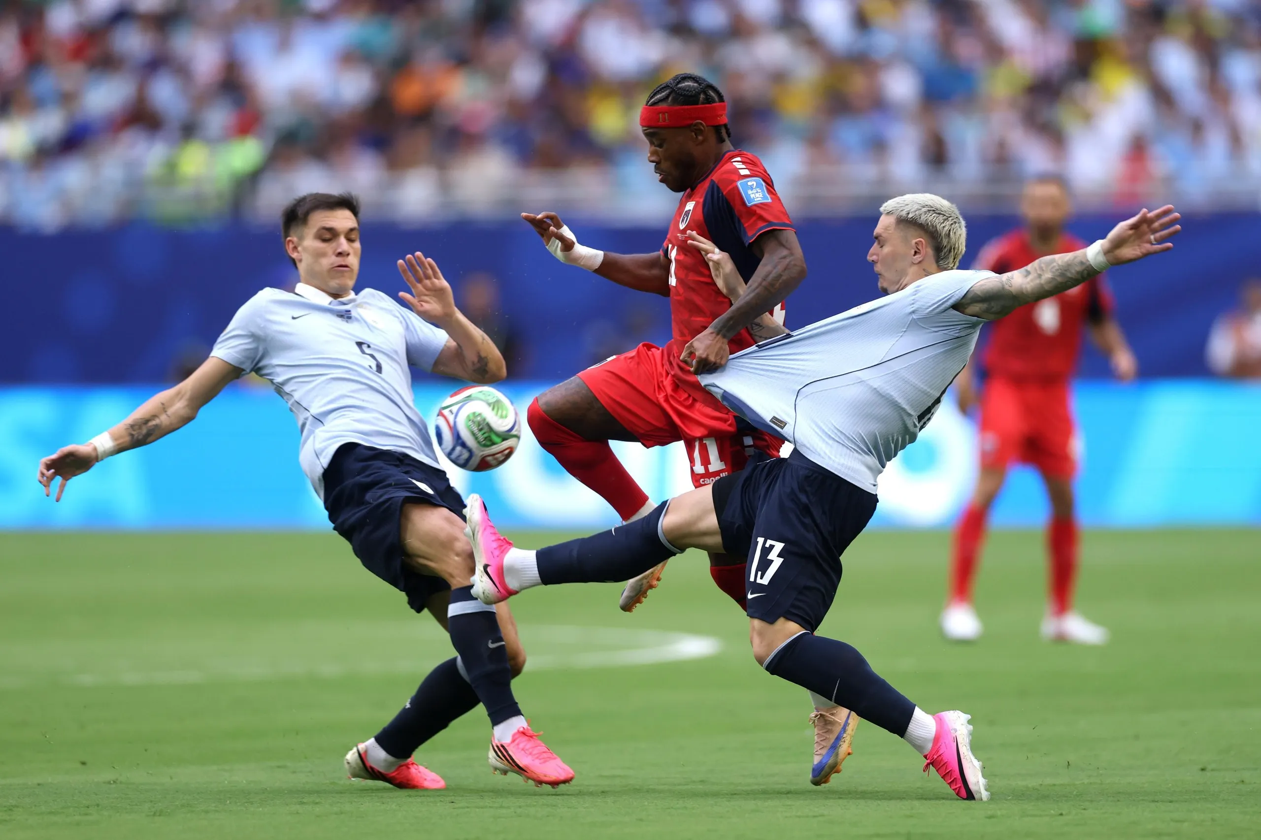 Cape Verde’s Garry Rodrigues competes for the ball against Manuel Ugarte and Guillermo Varela of Uruguay