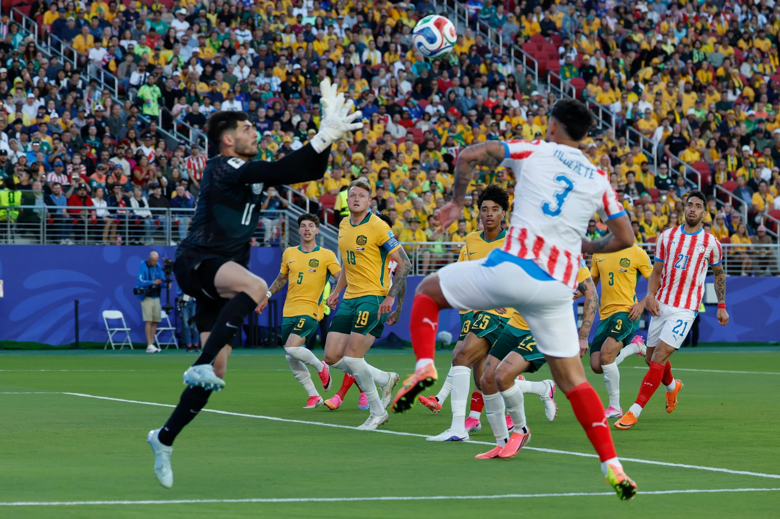 Australia look on as goalkeeper Orlando Gill of Paraguay secures the ball