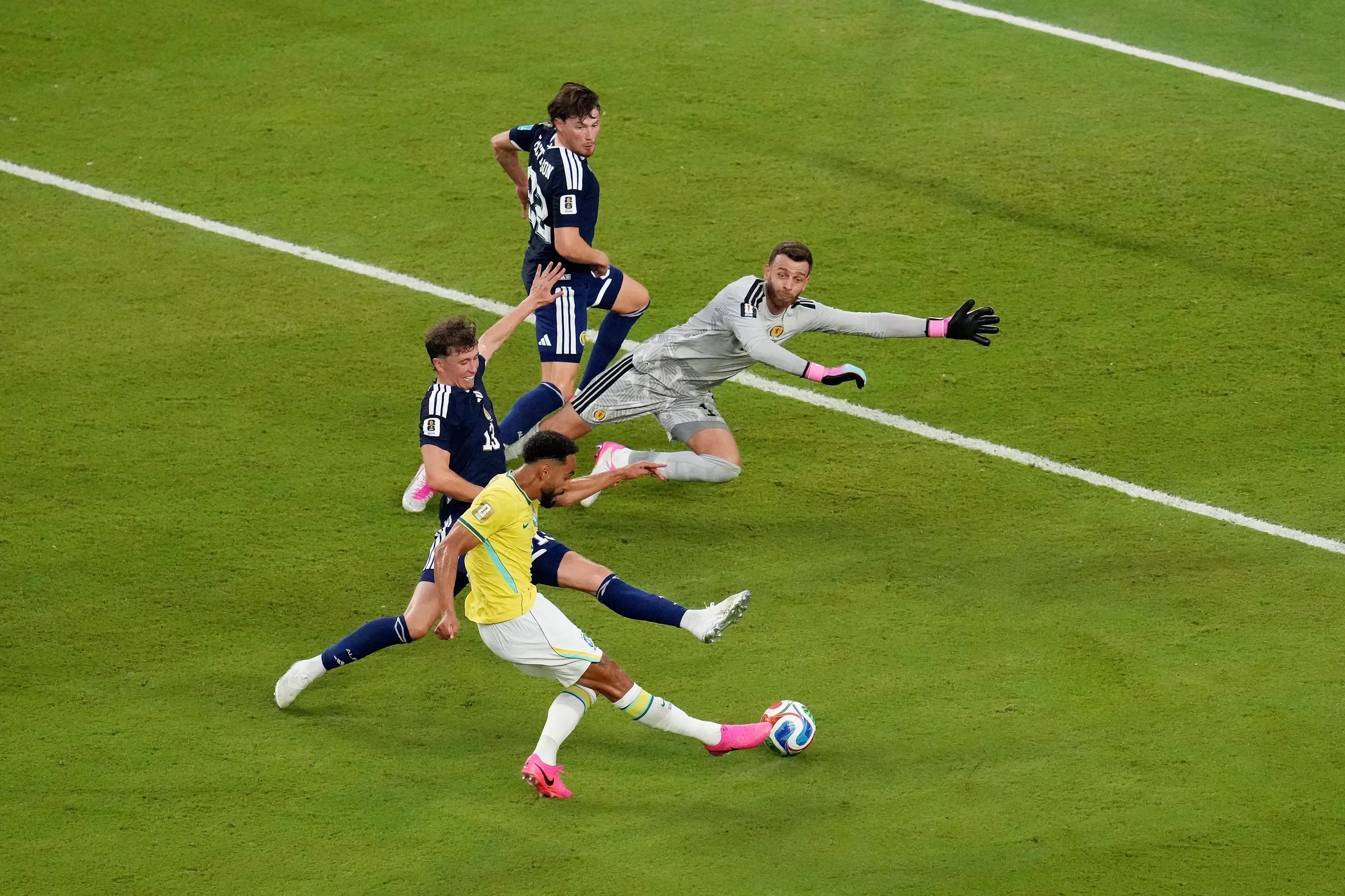 Matheus Cunha scores their third for Brazil past Angus Gunn.