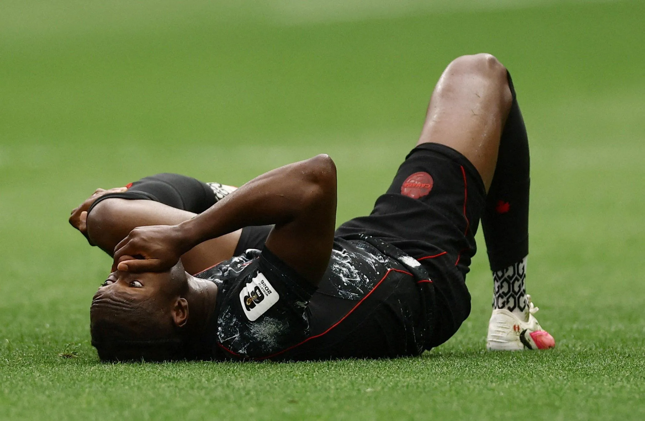 Canada’s Ismaël Koné on the ground after sustaining a broken leg against Qatar.
