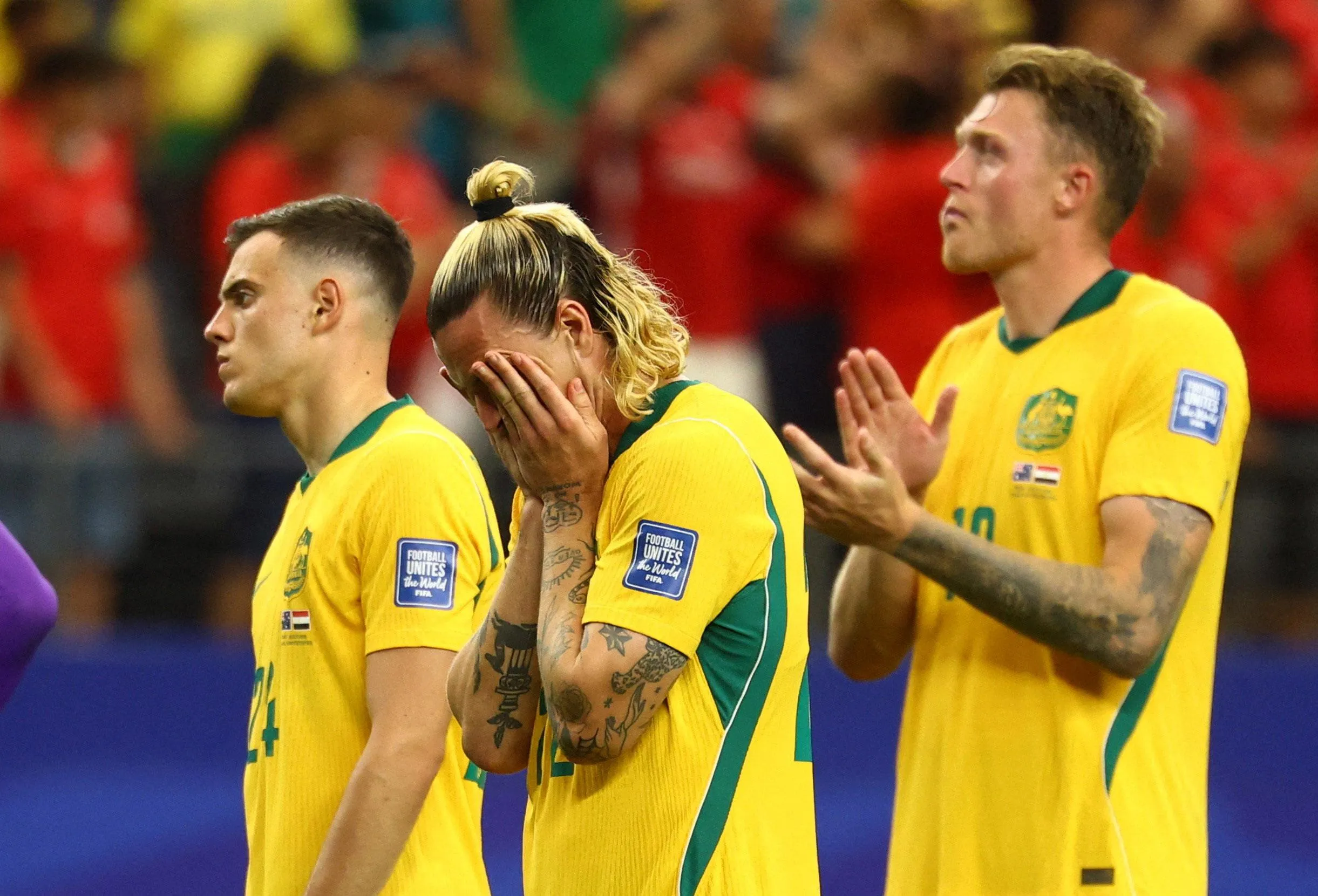 Jackson Irvine with his head in his hands