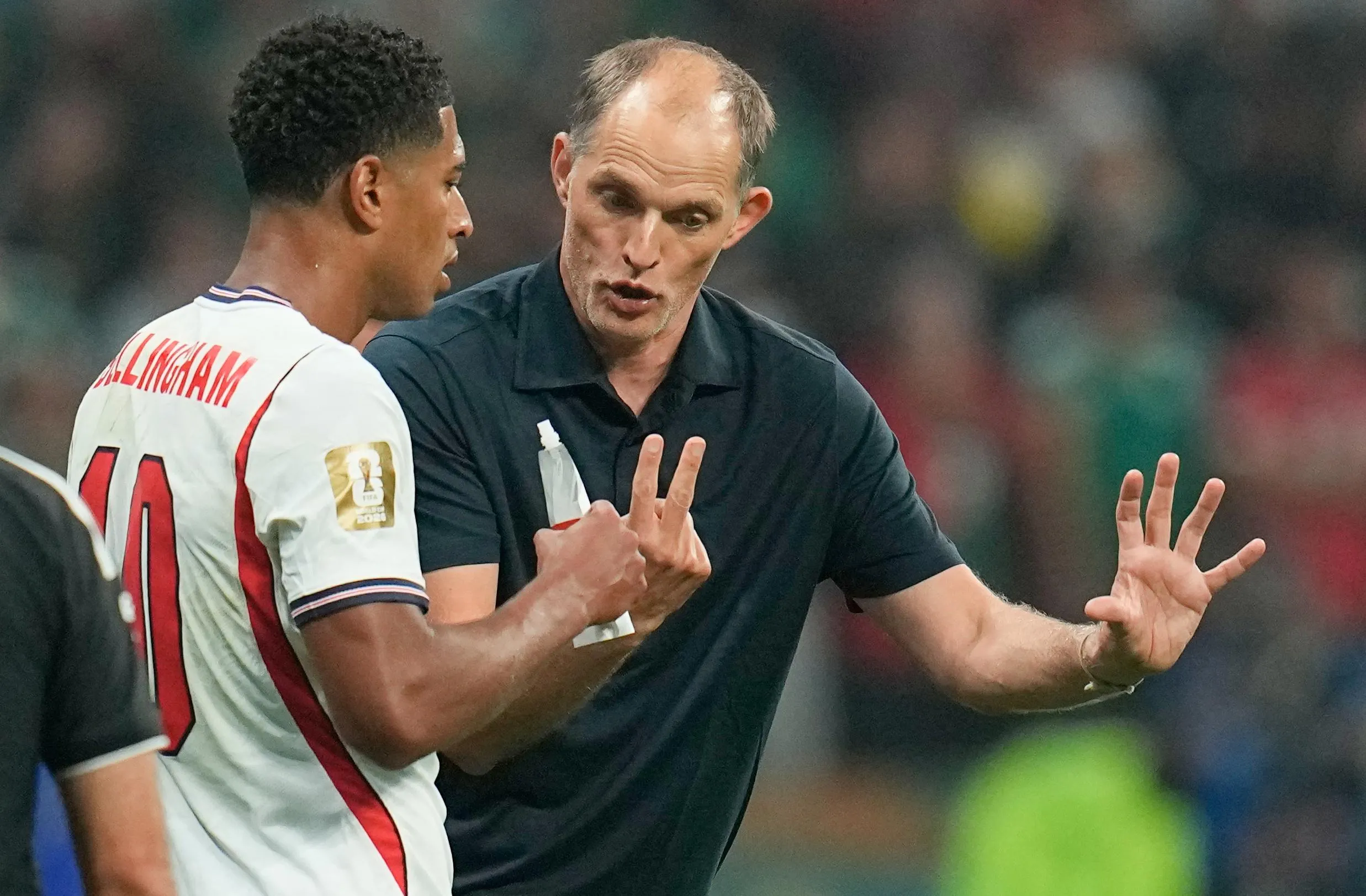 The England head coach, Thomas Tuchel, speaks with Jude Bellingham during the World Cup match against Mexico.