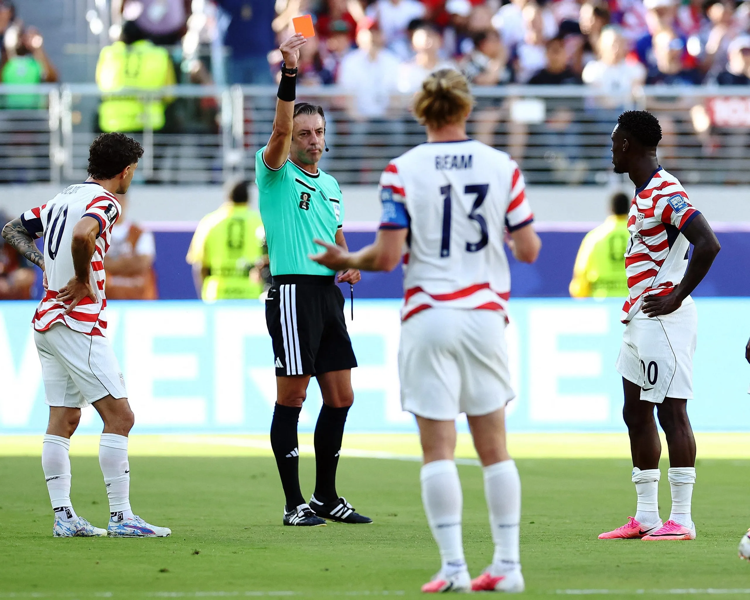Folarin Balogun of the US is shown a red card by referee Raphael Claus