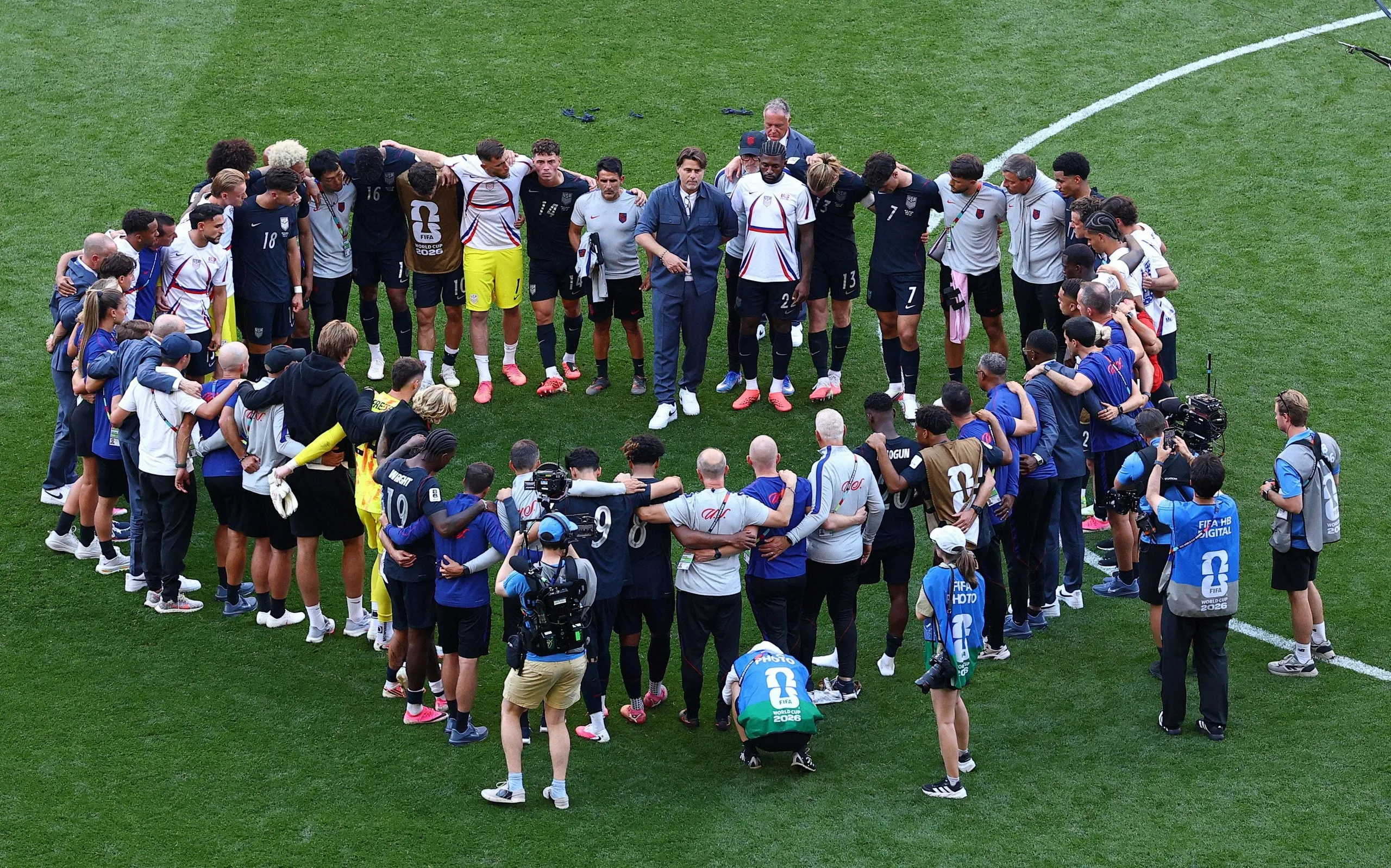Mauricio Pochettino speaks to his USA players after their defeat by Belgium