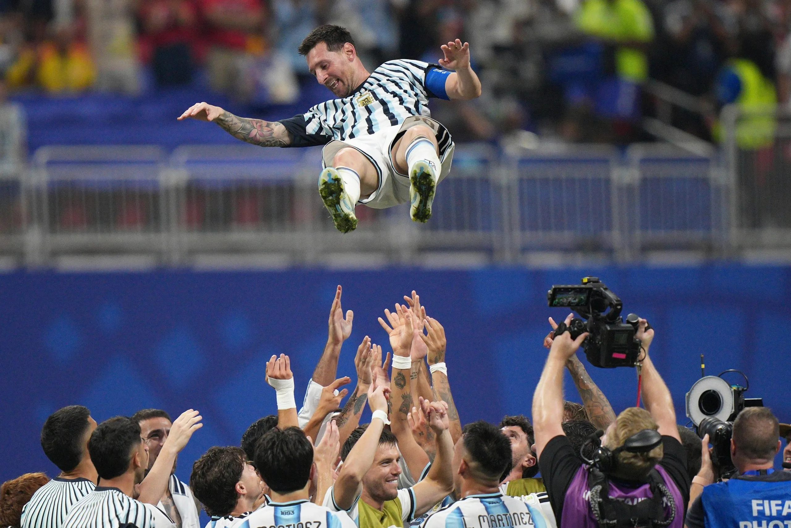 The Argentina players toss Lionel Messi into the air after beating Egypt