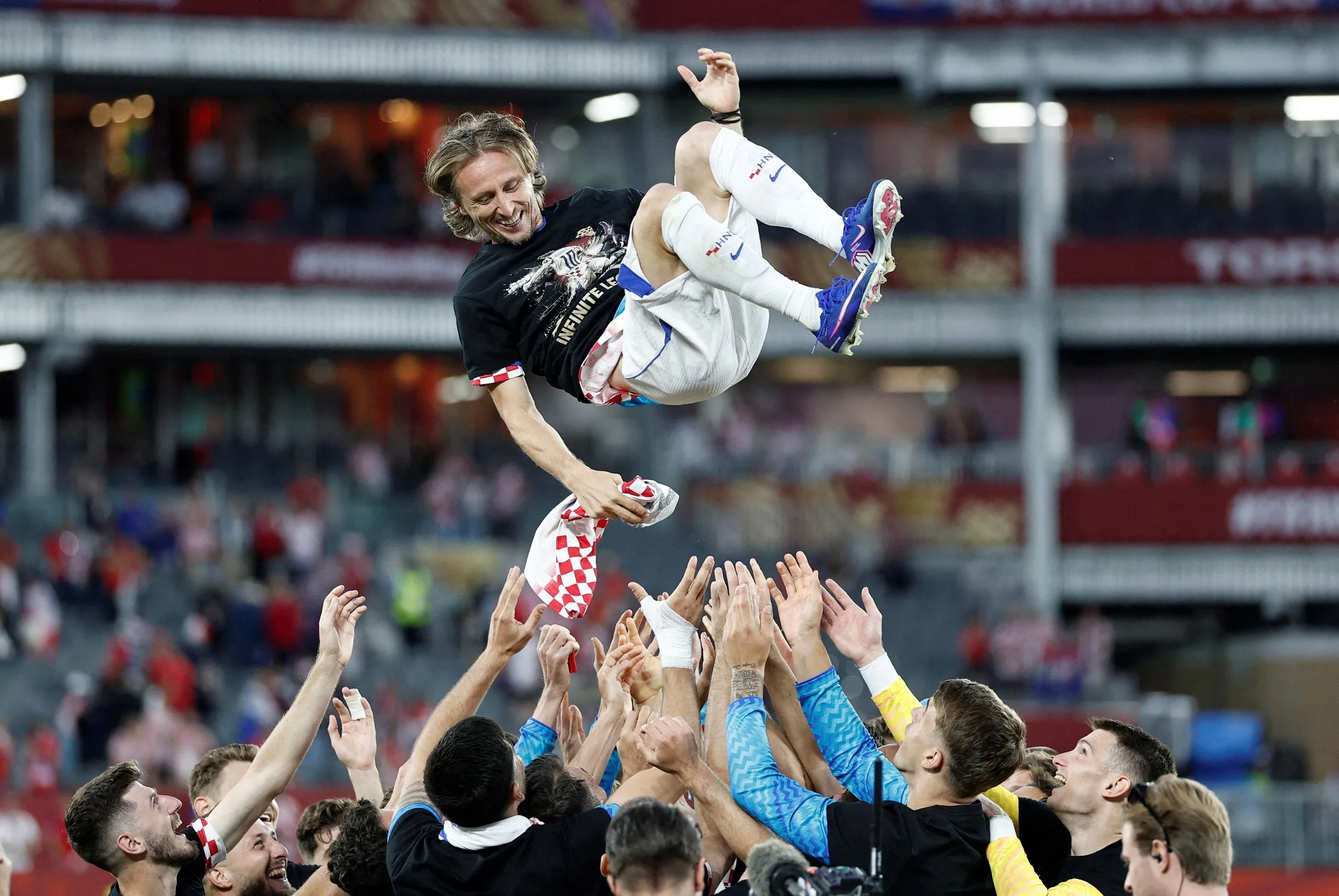 Luka Modric is thrown into the air by Croatia teammates in recognition of his 200th cap.