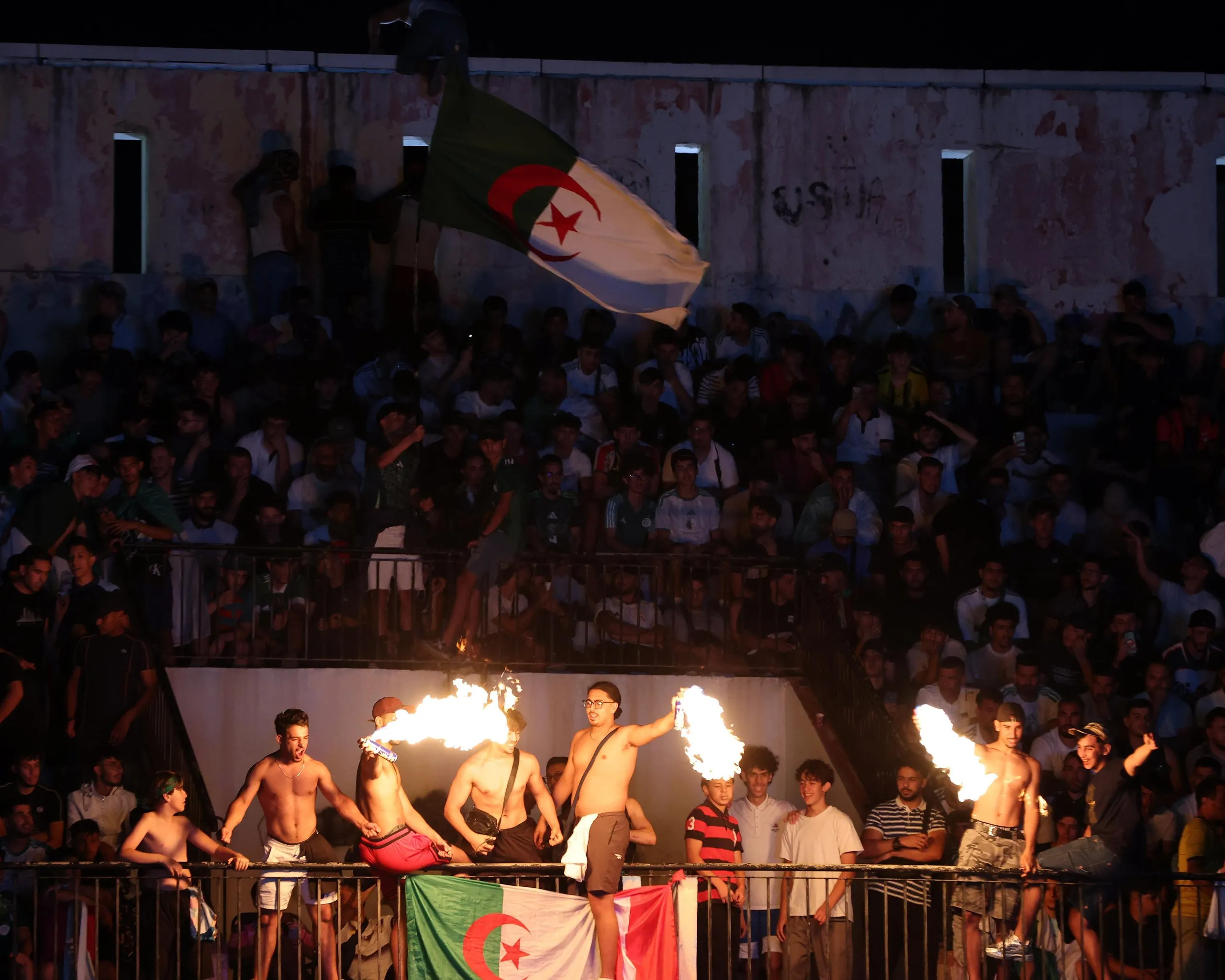 Supporters light flares at the screening of the game.