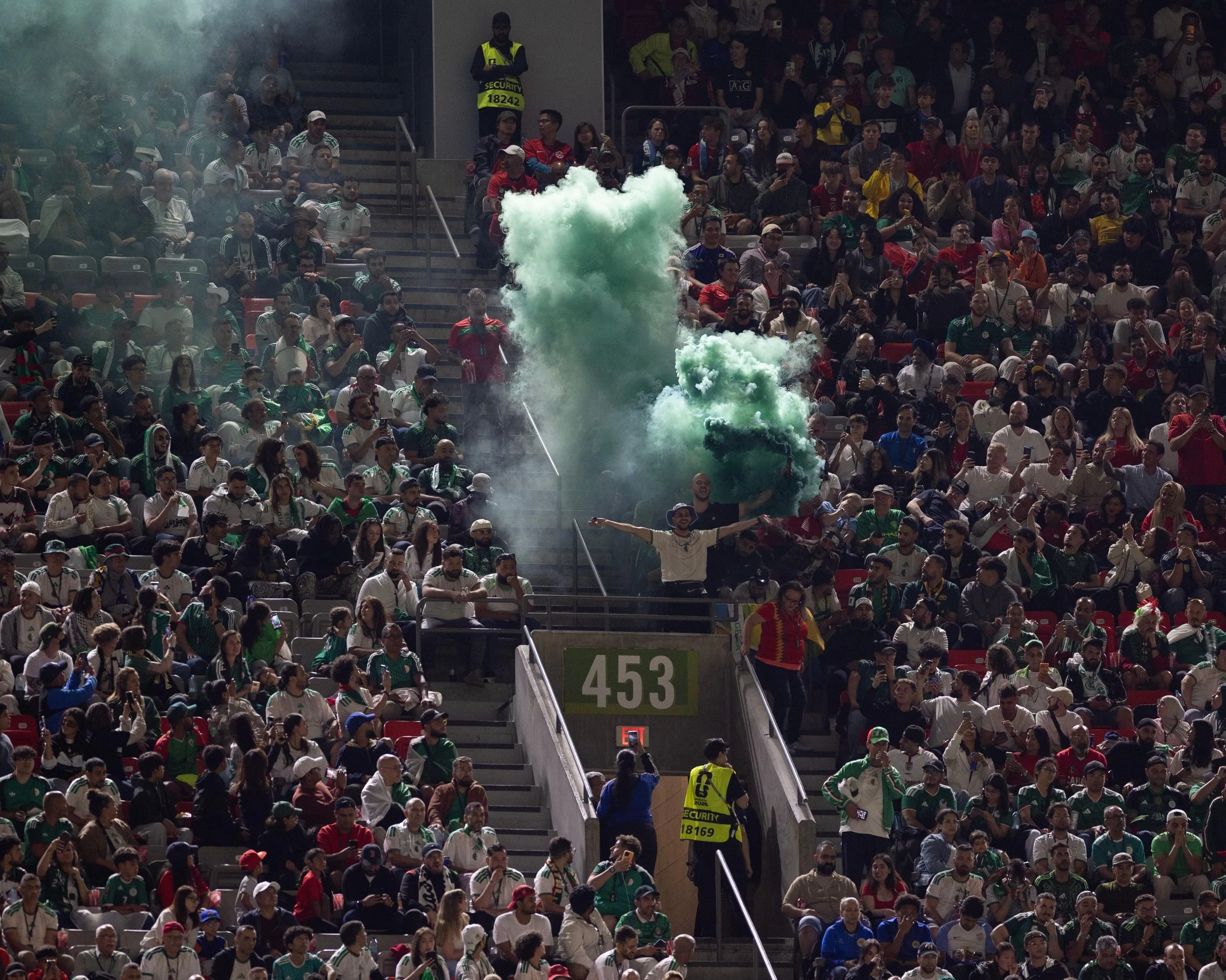 A spectator holds a smoke bomb during the match between Switzerland and Algeria at BC Place Vancouver.