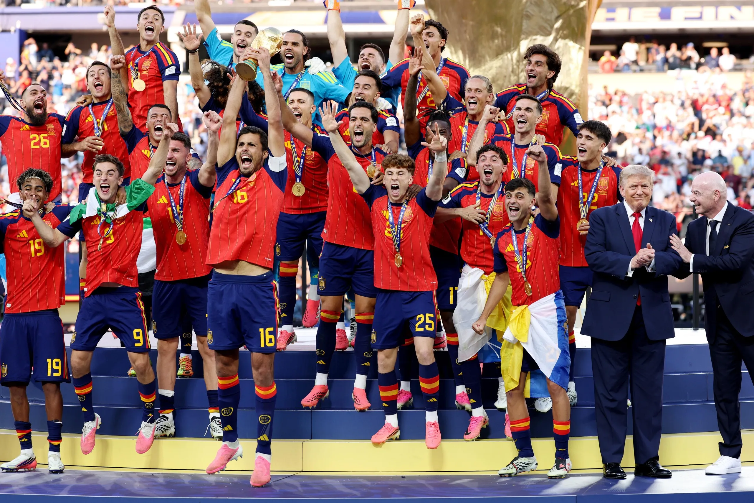 Rodri lifts the World Cup Trophy alongside Donald Trump and Gianni Infantino.